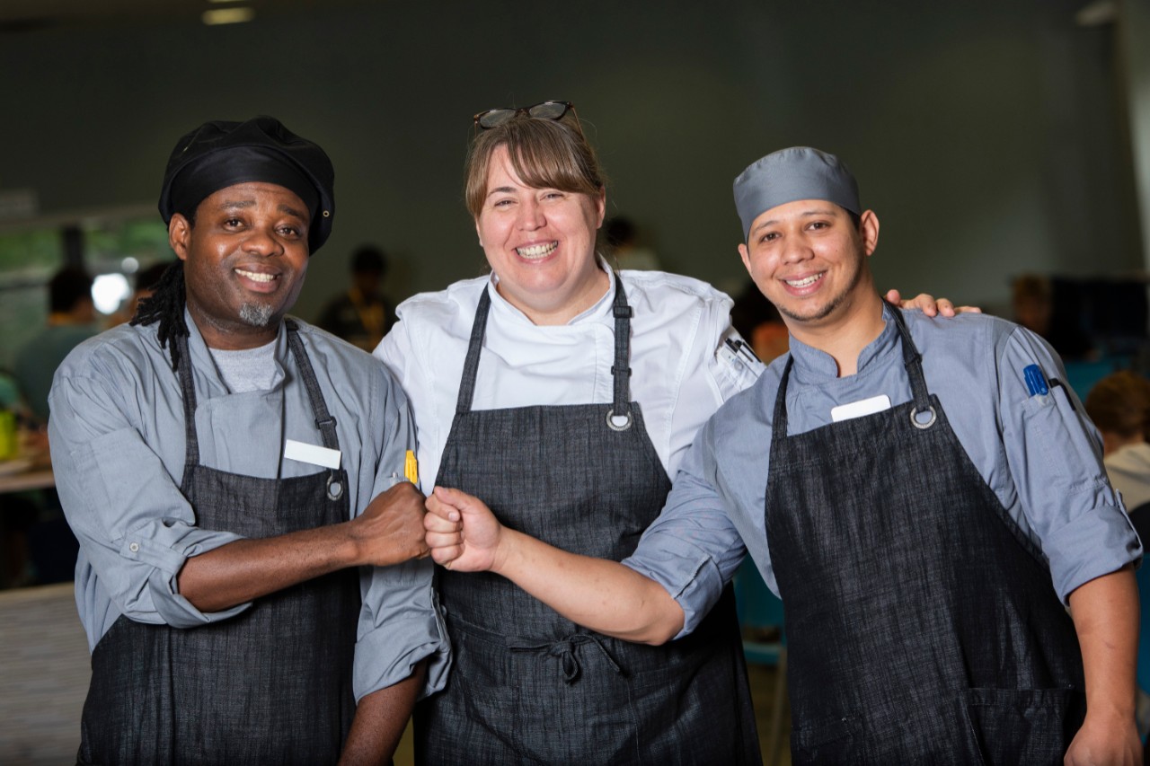Teamwork - chefs fist pumping and smiling