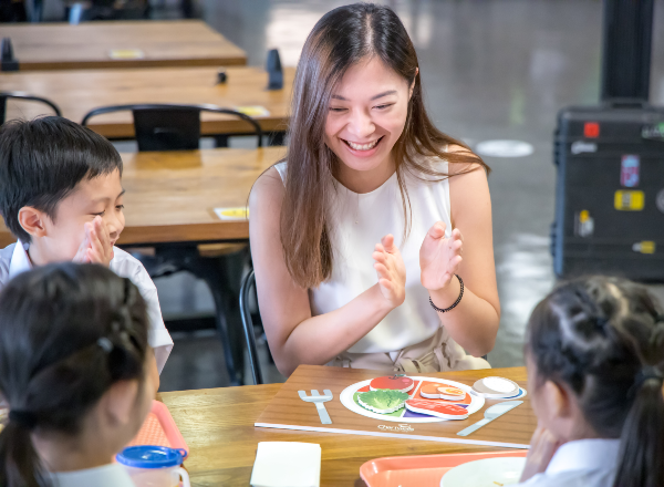 Teacher in classroom teaching children about nutrition