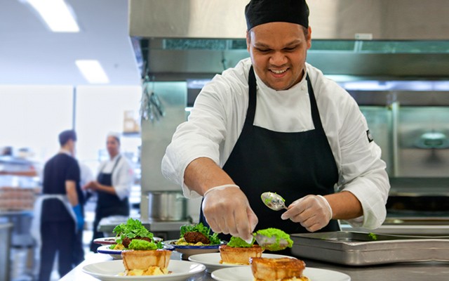 what we do, sectors page. Chef prepping pie and mash